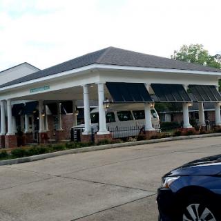 A charming restaurant featuring classic architectural elements and outdoor seating.