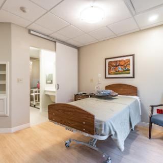A well-lit hospital patient room featuring a bed and an inviting atmosphere.