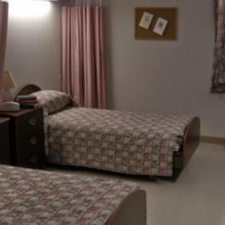 A cozy bedroom with twin beds and matching decor.