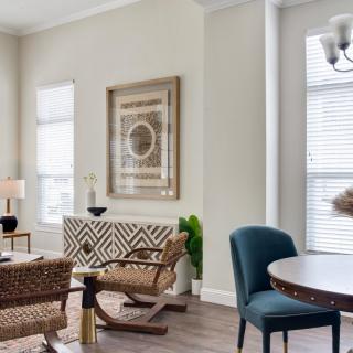 A modern living room with stylish furniture, artwork, and ample natural light.