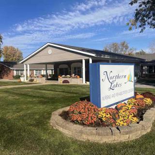A welcoming residential care facility surrounded by well-maintained landscaping.