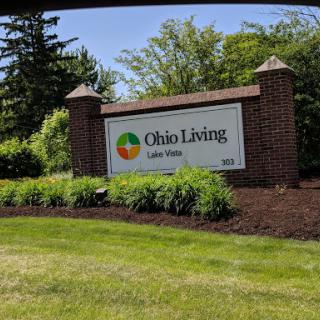 Entrance sign for Ohio Living, surrounded by lush greenery.