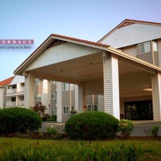 A modern hotel building with a welcoming entrance and well-maintained landscaping.