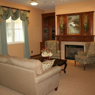 A cozy living room with a fireplace, sofa, and elegant decor.
