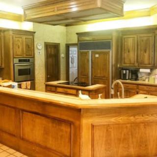 A spacious kitchen with wooden cabinets and modern appliances.