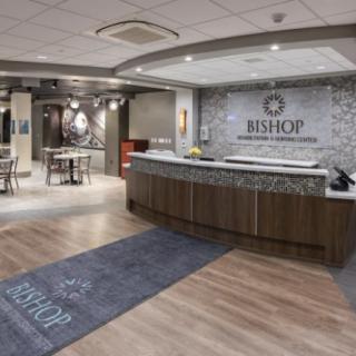A modern hospital reception area with a welcoming desk and seating.