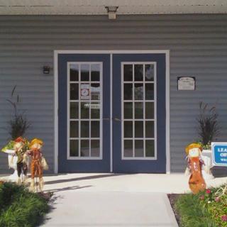 The entrance of a building decorated with seasonal figures on either side.