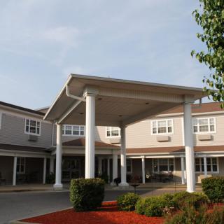 A front view of a building with prominent columns and well-maintained landscaping.