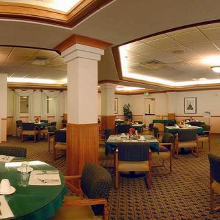 An elegant restaurant interior with neatly arranged tables and chairs.