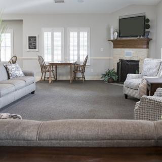 A spacious living room with cozy seating and a fireplace.