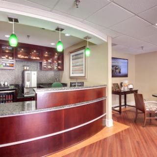 A modern reception area featuring a stylish bar and comfortable seating.