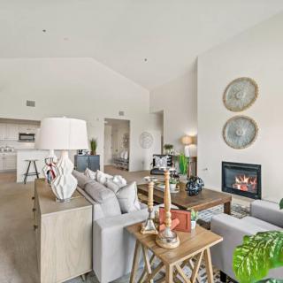 A modern living room with elegant decor and a cozy fireplace.