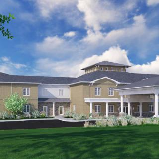 A modern two-story building with a landscaped lawn and cloudy sky backdrop.
