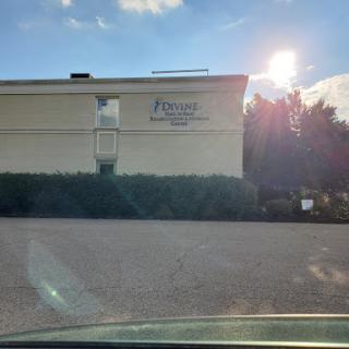 A sunny day highlights the facade of a building with visible signage.