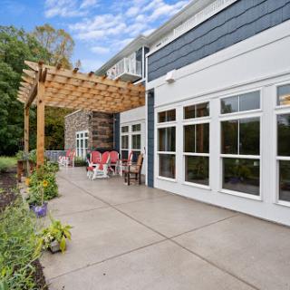 A serene outdoor patio area featuring a pergola and modern design elements, perfect for relaxation.