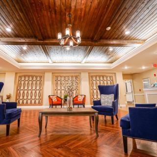 A spacious and elegant lobby with comfortable seating and a stylish wooden ceiling.