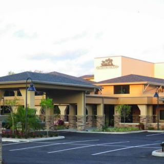 A hotel building with a surrounding parking lot.