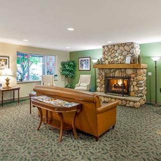A cozy living room with a stone fireplace and elegant furnishings.