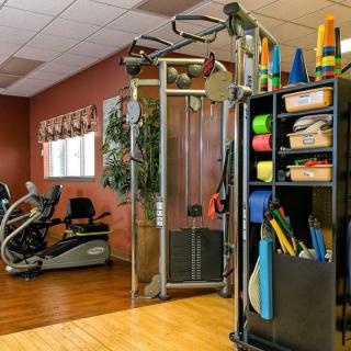 A well-equipped gym with exercise machines and training tools.