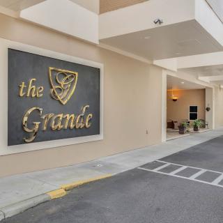 Entrance of a building with 'The Grande' sign.