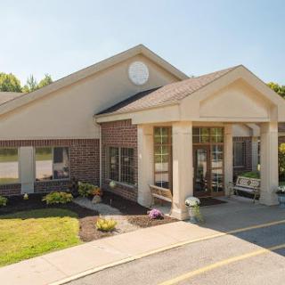 A welcoming entrance to a well-maintained commercial building on a sunny day.