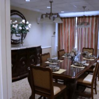 A neatly arranged dining room with an elegant table setting and stylish decor.