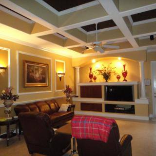 A warmly lit living room with elegant decor and comfortable seating.