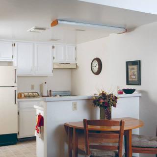 A cozy kitchen and dining area with a small table, chairs, and decorative elements.