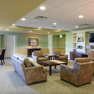 A cozy living room with comfortable seating and a bookshelf.