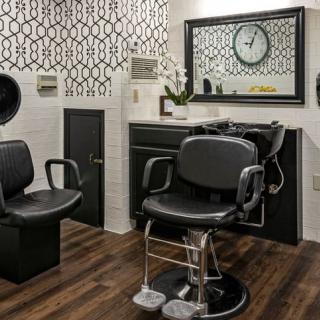 Modern barbershop interior with stylish decor and equipment.