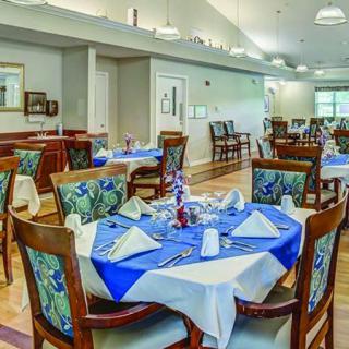 A well-decorated dining room with neatly arranged tables and chairs.