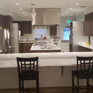 A spacious modern kitchen with a large countertop and stainless steel appliances.