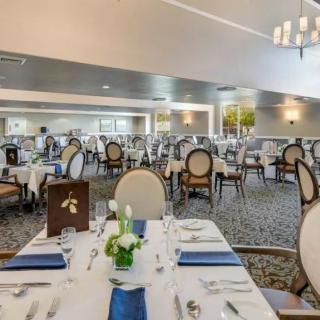 An elegant dining room set up with neatly arranged tables and chairs.