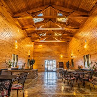 A spacious wooden lodge interior with high ceilings and seating area.