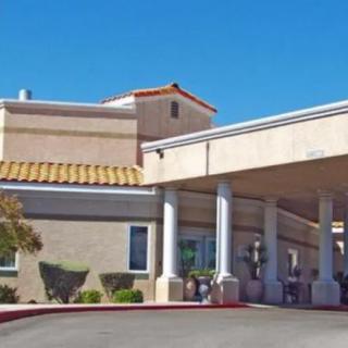 Entrance of a building with columns and a tiled roof, possibly a hotel.