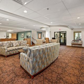 A spacious lobby area with comfortable seating and a warm atmosphere.