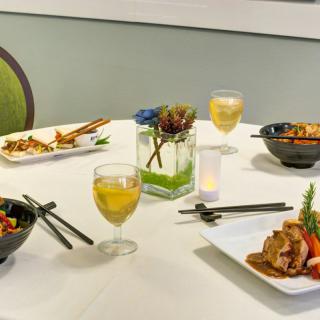 A beautifully set dining table with a variety of dishes and drinks.