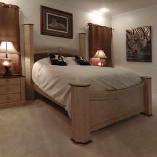 A cozy bedroom with a wooden bed and matching nightstands, softly lit by table lamps.