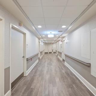 A clean and well-lit hospital hallway, showcasing a modern interior design.