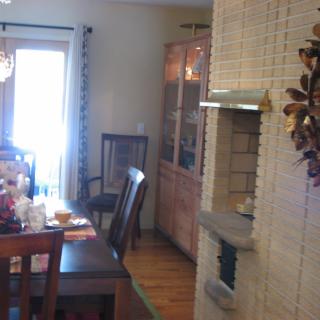 A cozy dining room with a wooden table set and decorative elements.