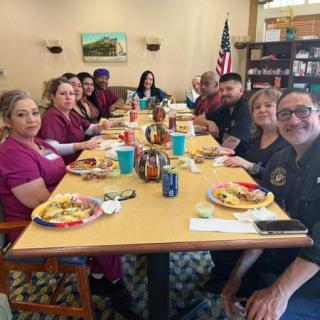 A group of people enjoying a meal together at a restaurant table.