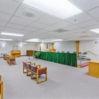 A spacious courtroom with seating arrangements and a judge's podium.