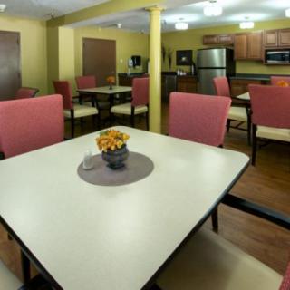 A modern kitchen and dining area with tables and chairs.