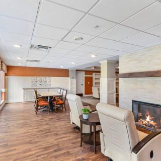 A modern living room interior with comfortable seating and a fireplace.