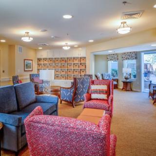 A bright and cozy lounge area with various chairs and sofas.