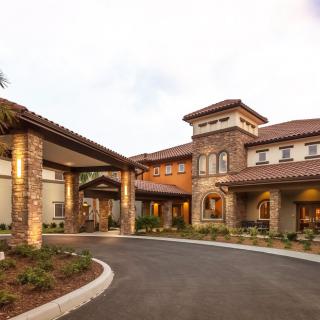 A beautifully designed building with a welcoming entrance and well-manicured landscaping.