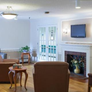 A cozy living room featuring comfortable seating, a fireplace, and a mounted television.