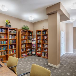 A cozy library corner with bookshelves filled with various books.