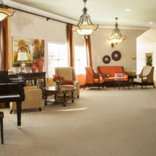 Spacious living room with a piano and elegant furnishings.