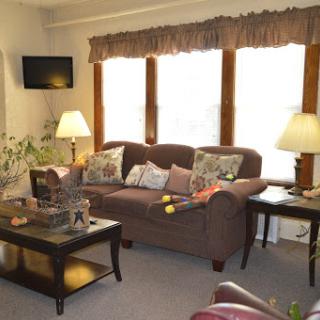 A cozy living room with a comfortable sofa, decorative pillows, and warm lighting.